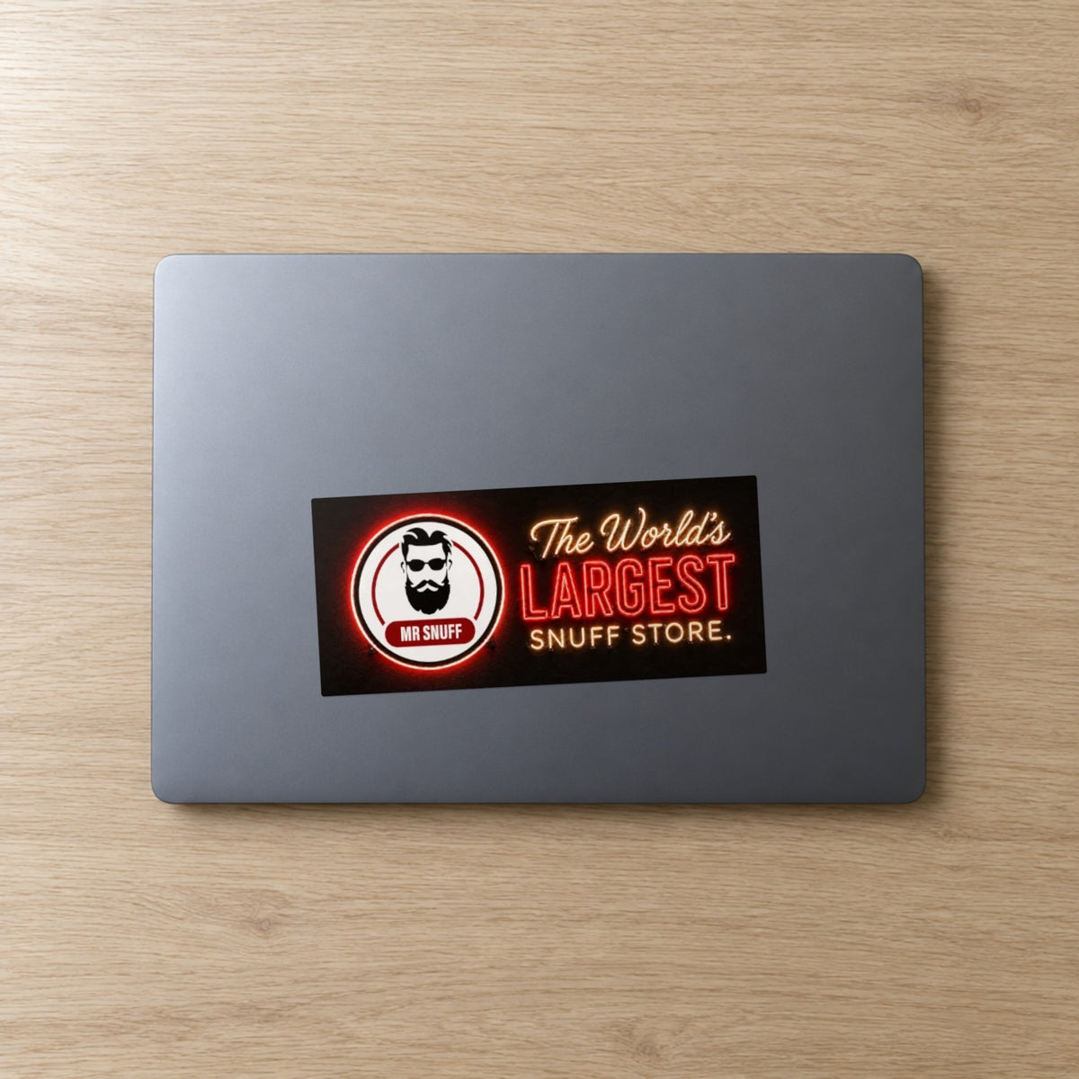 Mr Snuff Neon bumper sticker, 180 x 80 mm, on a laptop lid